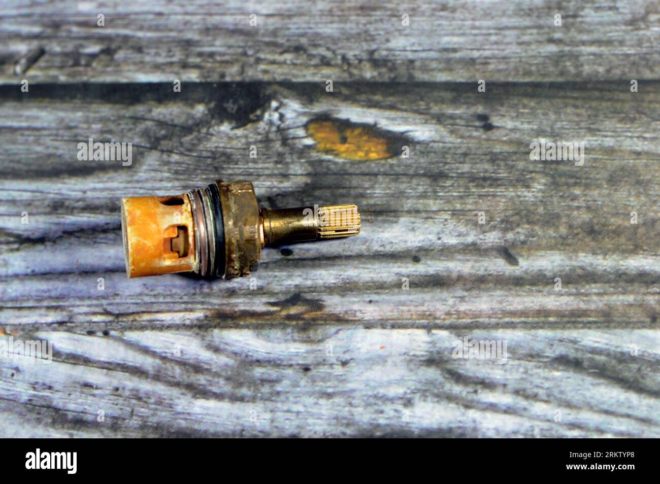 A used shower faucet tap body cartridge parts of plastic and copper