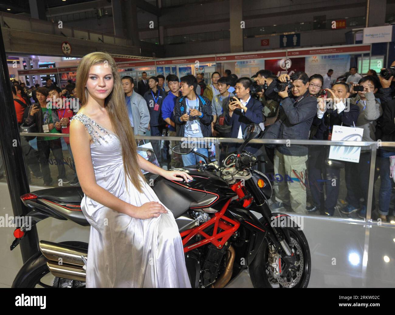 Bildnummer: 58577703  Datum: 11.10.2012  Copyright: imago/Xinhua (121011) -- CHONGQING, Oct. 11, 2012 (Xinhua) -- A model sits on a motorcycle exhibited in the 11th China International Motorcycle Trade Exhibition in southwest China s Chongqing Municipality, Oct. 11, 2012. More than 400 motorcycle companies from 10 countries and regions attended the four-day expo kicked off on Thursday. About 100 international traders also participated in the fair, and the purchase sum is expected to exceed 100 million U.S. dollars. (Xinhua/Liu Chan) (hy) CHINA-CHONGQING-MOTOR CYCLE EXPO-OPENING (CN) PUBLICATIO Stock Photo