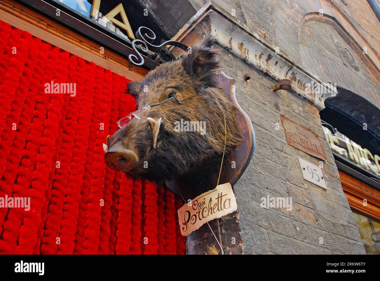 Boar s head wearing glasses with porchetta sign Siena Tuscany Italy