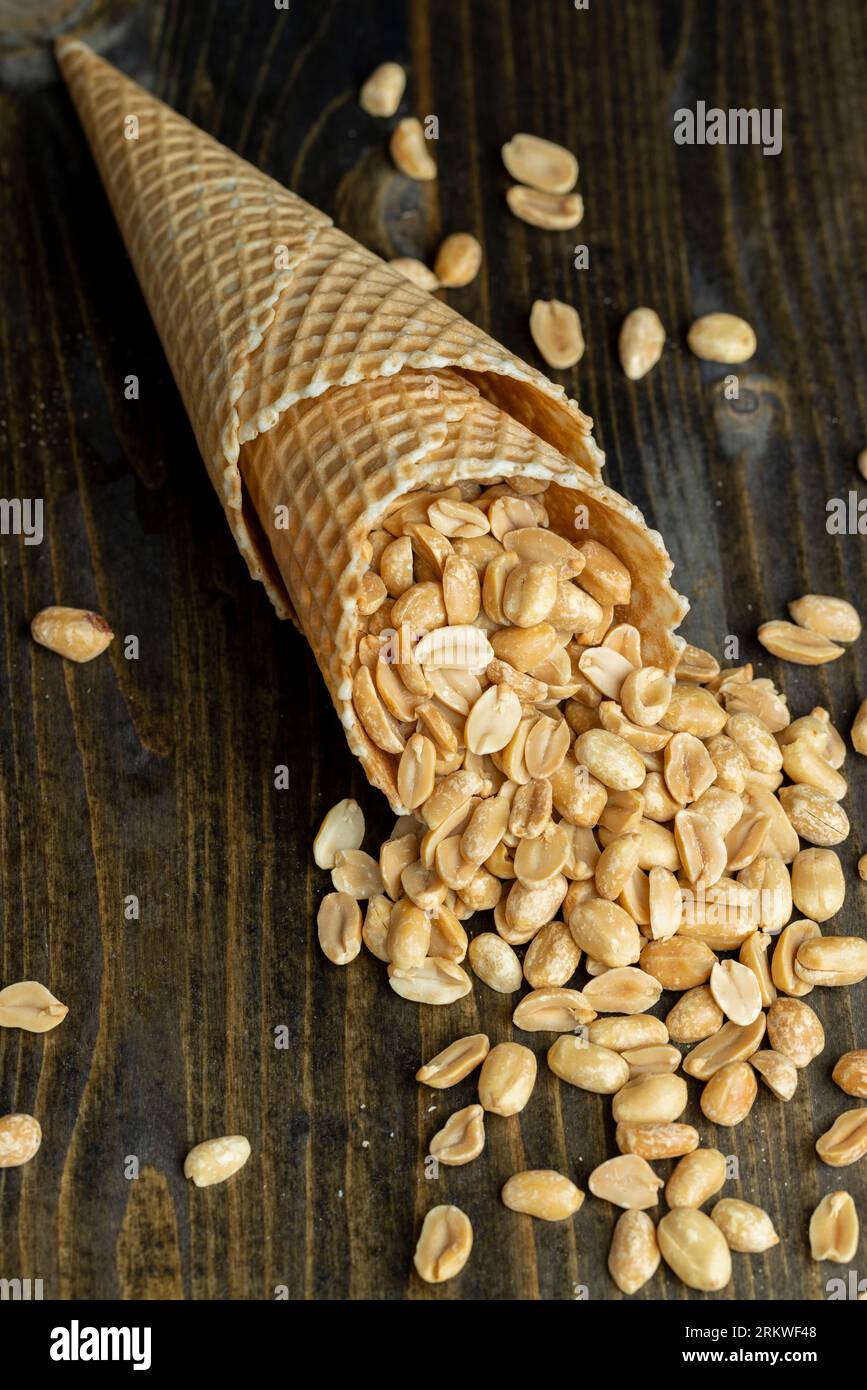 Roasted crispy peanuts in a waffle cone for ice cream, a bunch of ripe and delicious peanuts