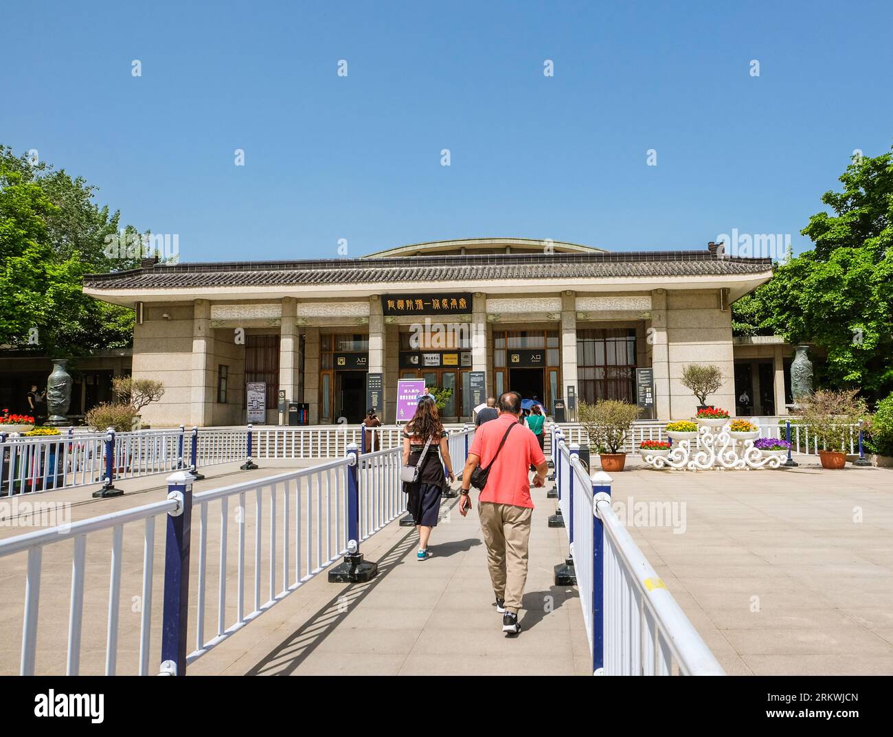 Xian, China - May 2021: Tourists walking between barriers to a museum site building containing the Terracotta Army, part of the Mausoleum of the First Stock Photo