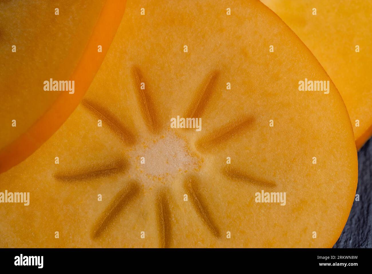 Half-cut ripe and sweet persimmon, details of the pulp of ripe ...