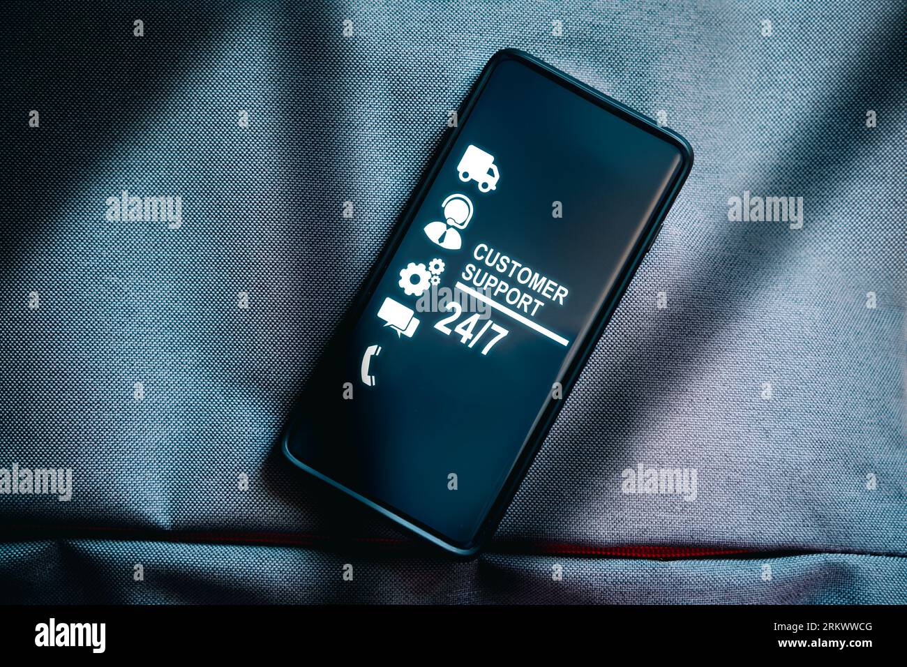 Top view of smartphone with 24-7 nonstop and full-time available service on screen. Assistance customer support hotline people connect. Feedback. Stock Photo