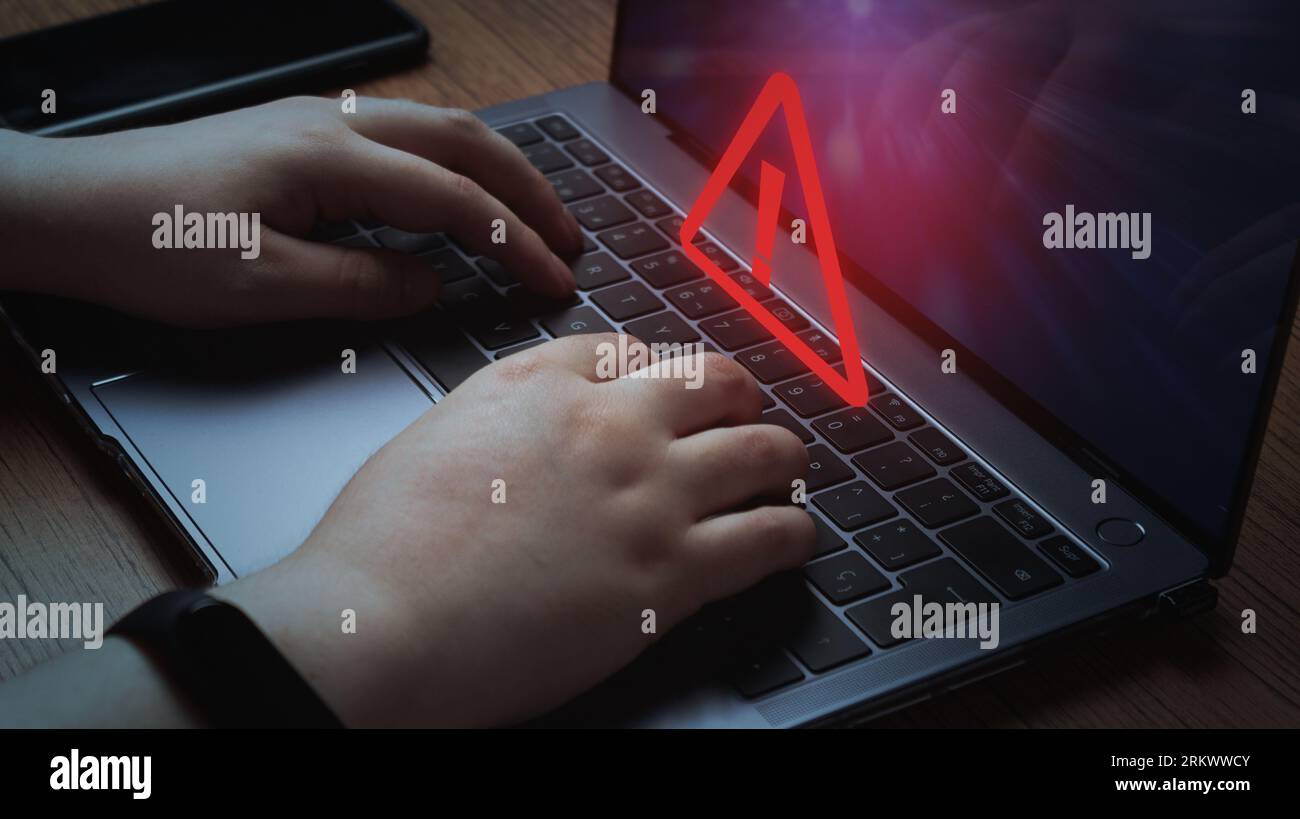 Woman use laptop with system hacked alert. Compromised information concept. Internet virus cyber security and cybercrime. Stock Photo