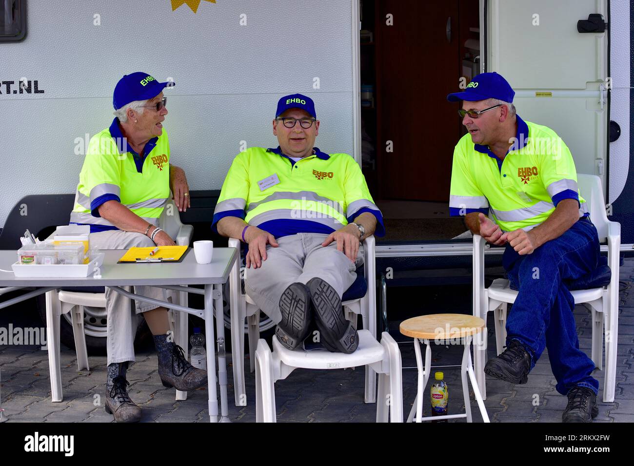 Emergency workers at their posts Three older first aiders have a quiet moment, flower parade Zundert Stock Photo
