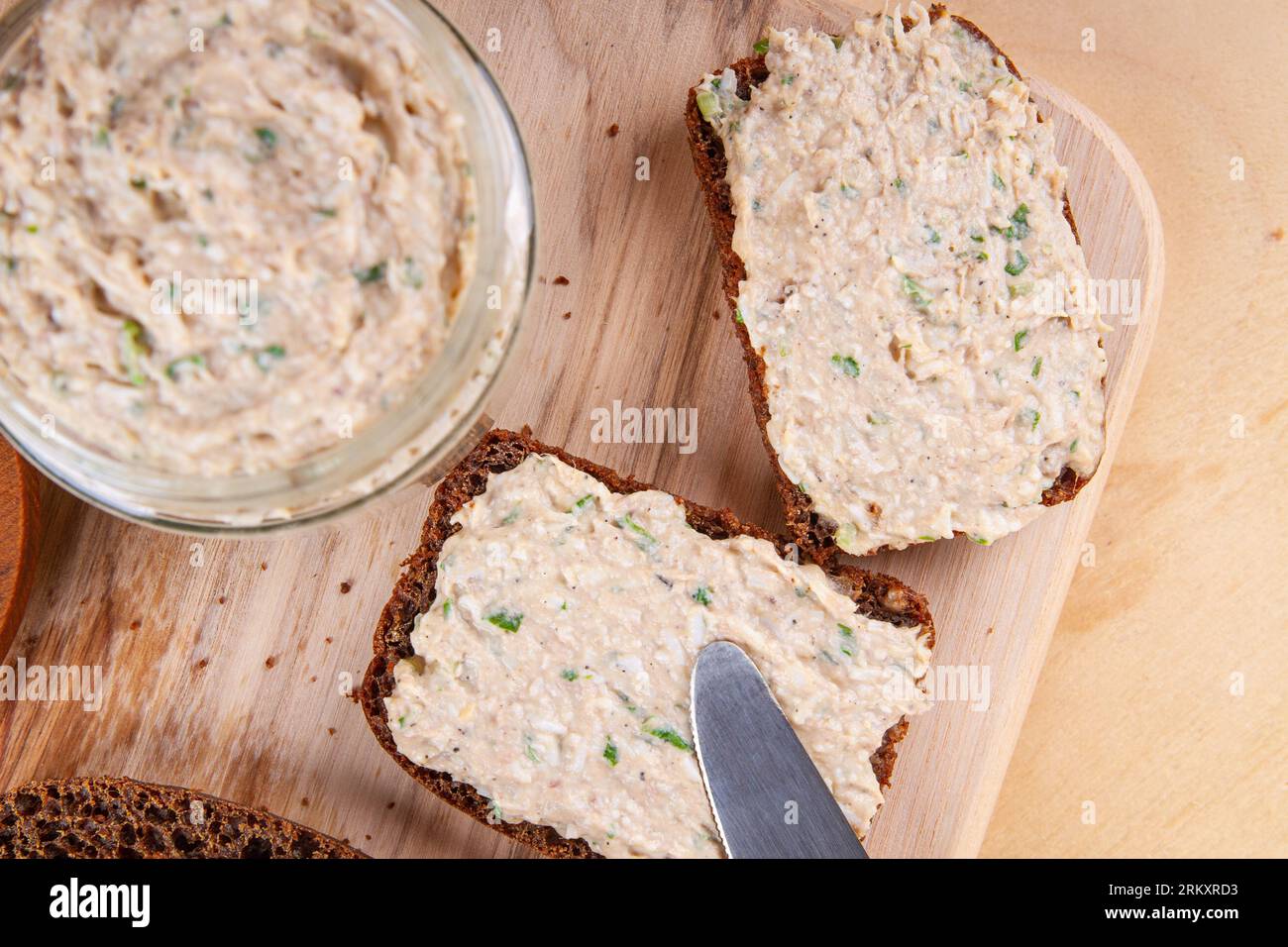 Indulge in homemade pate made from liver, eggs, yogurt and chives, served alongside slices of rye bread Stock Photo