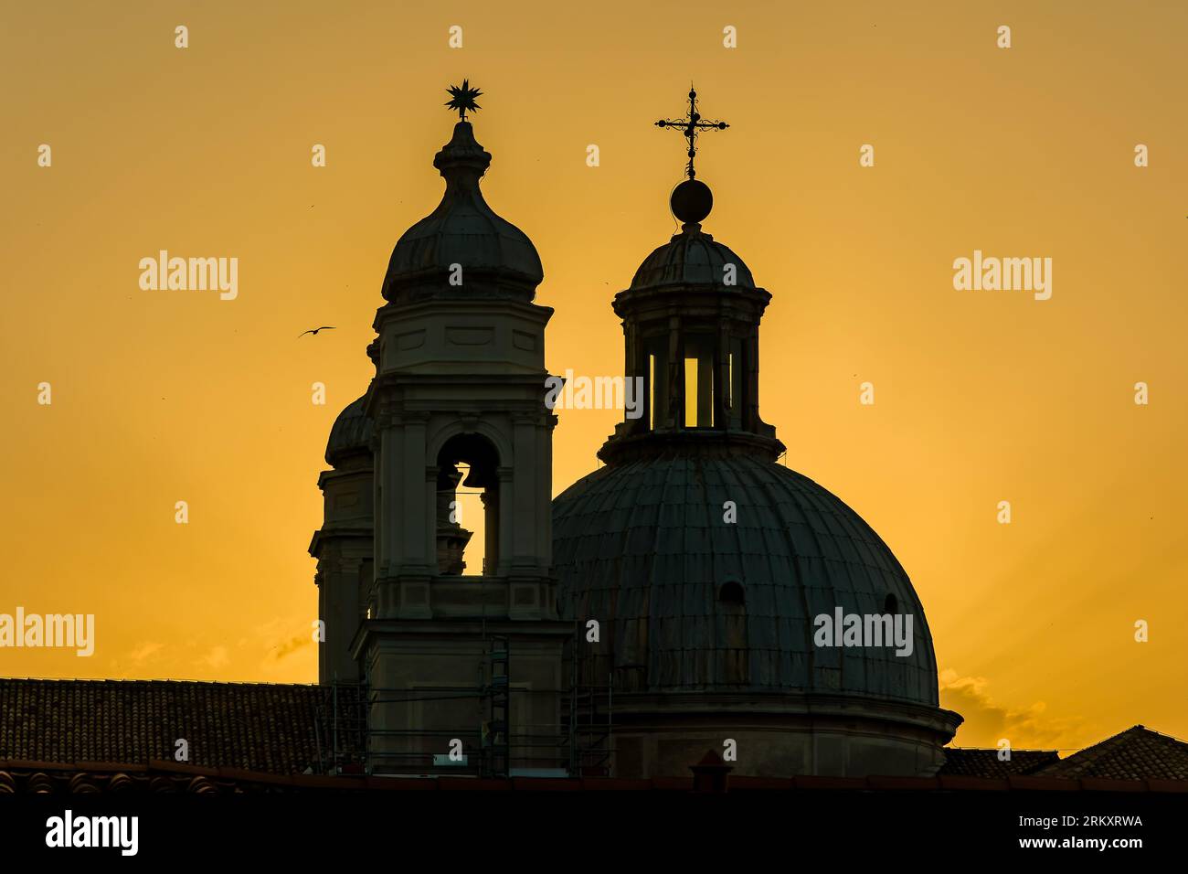 Sunset silhouette of ancient church spires in the Italian city of ...
