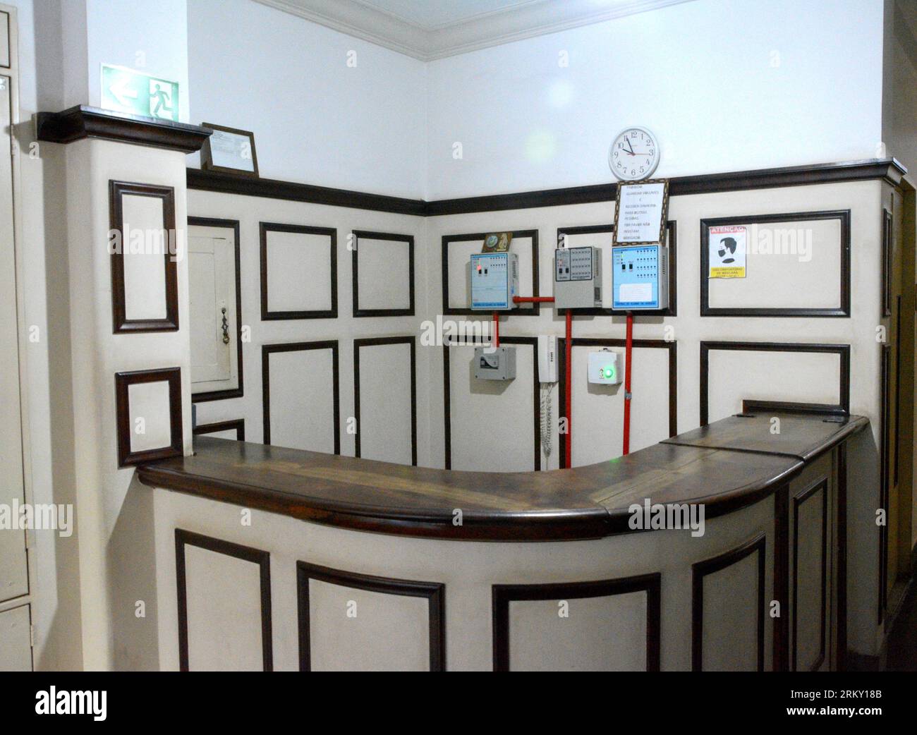 Old building entrance hall with counter, clock and equipment. Brazil Stock Photo