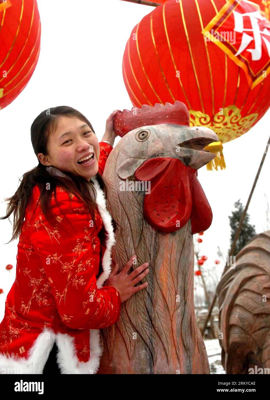 Bildnummer: 59195393  Datum: 09.02.2013  Copyright: imago/Xinhua (130209) -- ZHENGZHOU, Feb. 09, 2013 (Xinhua) -- File photo taken on Feb. 9, 2005 shows a woman posing for a photo with a stone sculpture of rooster at a temple fair in Zhengzhou, capital of central China s Henan Province. 2005 was the Year of the Rooster in the Chinese Zodiac. Chinese Zodiac is represented by 12 animals to record the years and reflect people s attributes, including the rat, ox, tiger, rabbit, dragon, snake, horse, sheep, monkey, rooster, dog and pig.(Xinhua/Wang Song) (mp) CHINA-LUNAR NEW YEAR-CHINESE ZODIAC (CN Stock Photo
