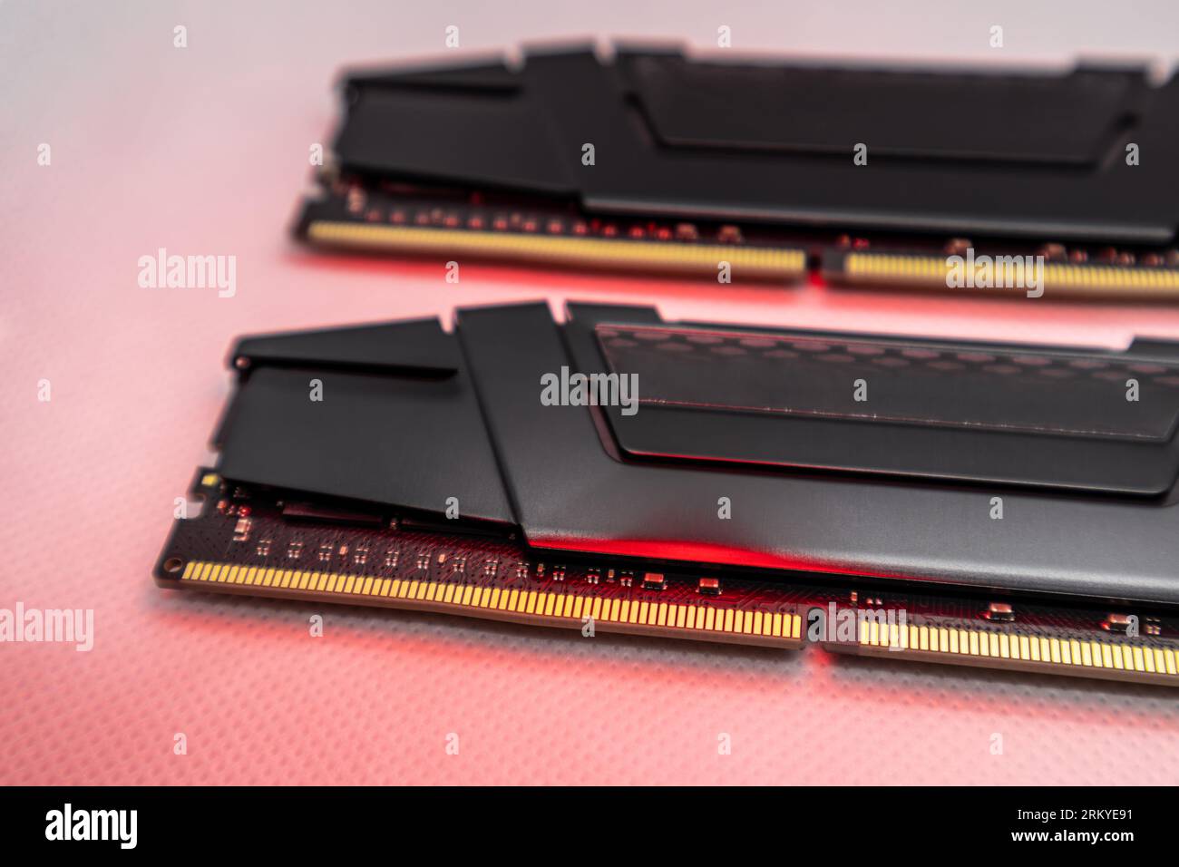 DDR4 DRAM memory modules in red light. Computer RAM chip close-up on white. Desktop PC memory parts for assemble Stock Photo