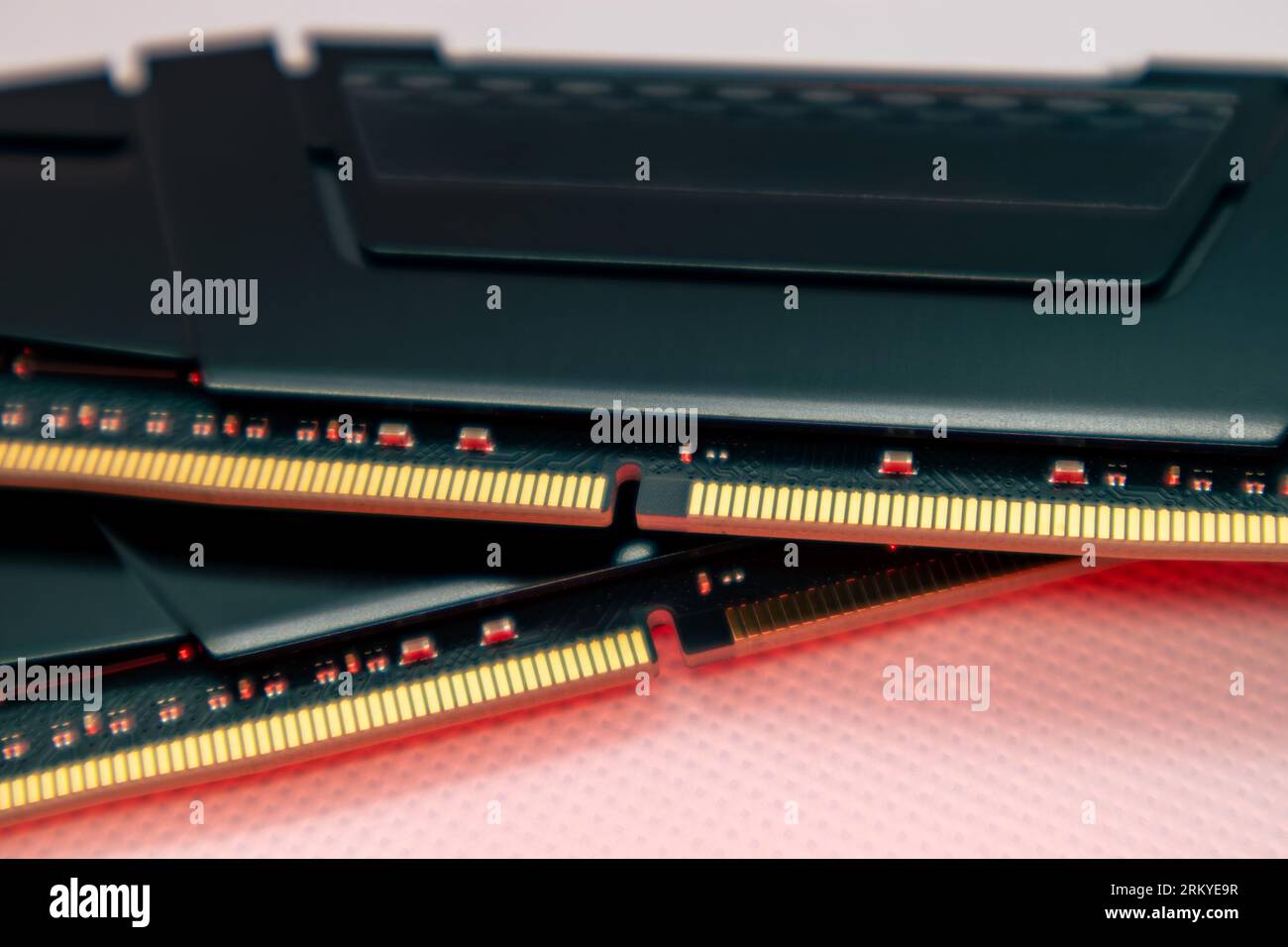DDR4 DRAM memory modules in red light. Computer RAM chip close-up on white. Desktop PC parts for assemble Stock Photo