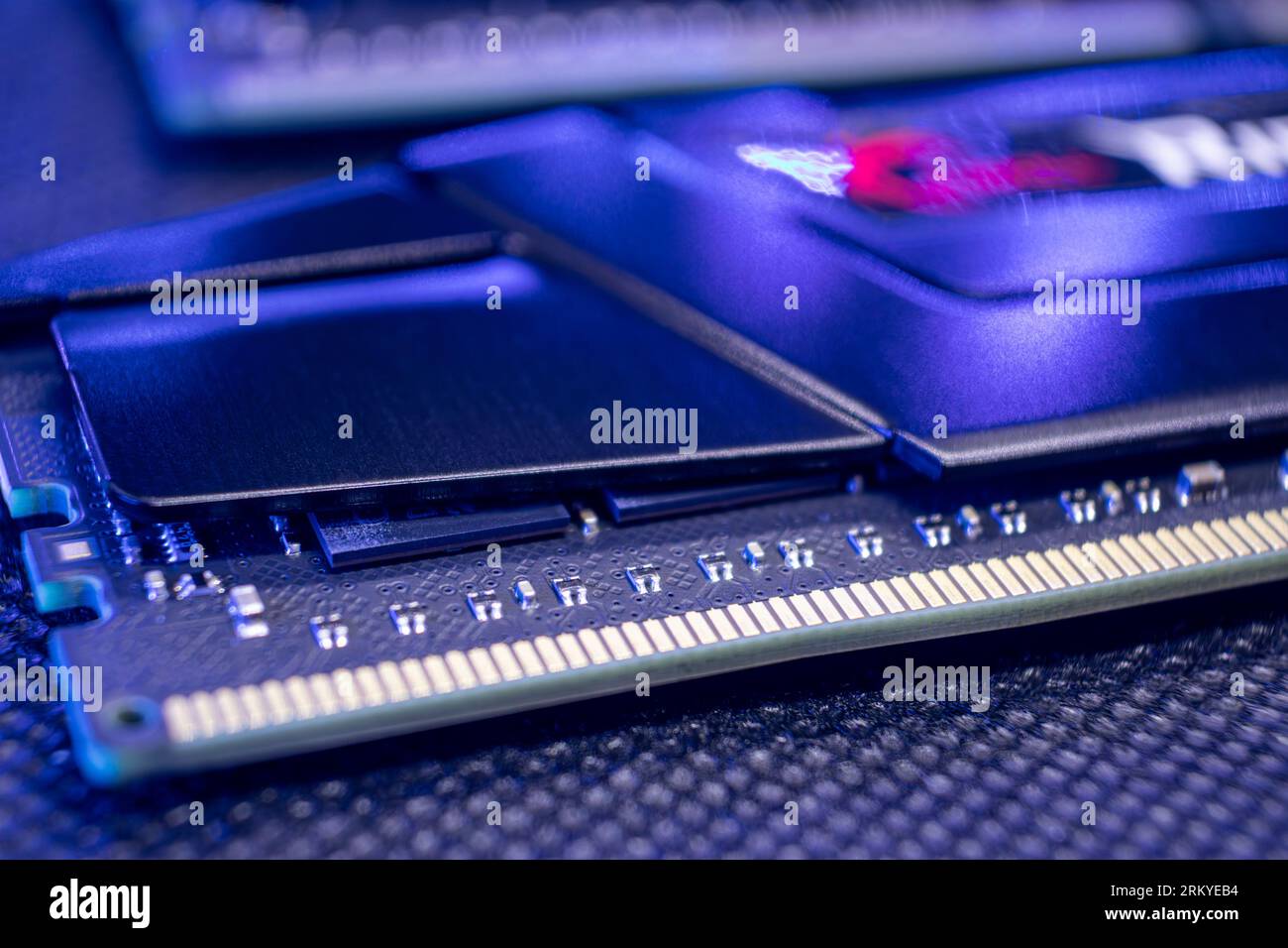 DDR4 DRAM memory module macro in purple light. Computer RAM chipset close-up. Desktop PC hardware components Stock Photo