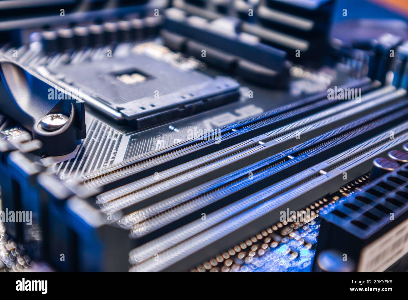 Modern PC motherboard with AM4 CPU Socket. Computer hardware chipset components close-up in blue light. Tech industry electronics background Stock Photo