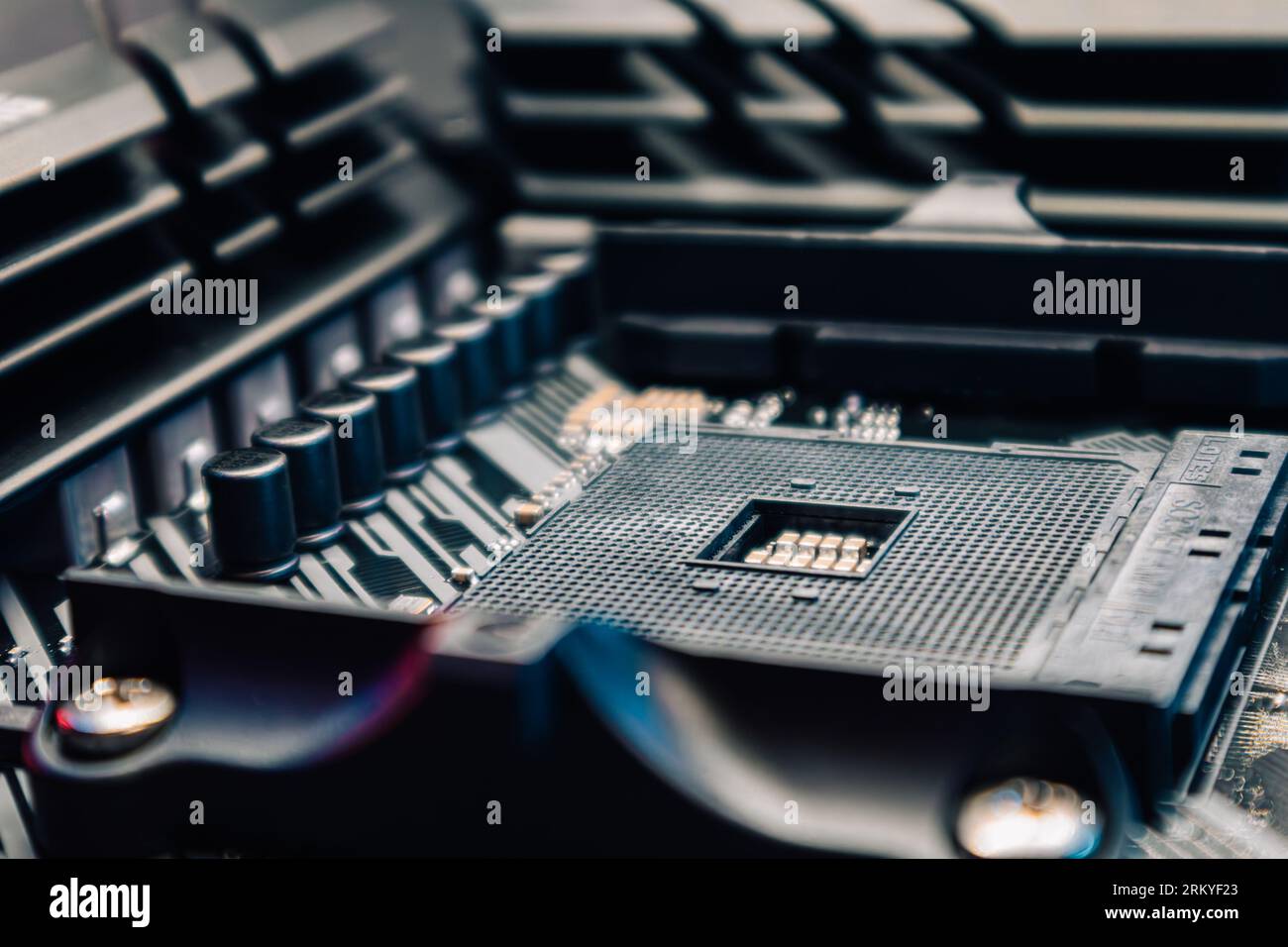 AM4 CPU Socket on motherboard of powerful desktop PC. Computer hardware chipset components close-up in blue light. Tech industry electronics backgroun Stock Photo