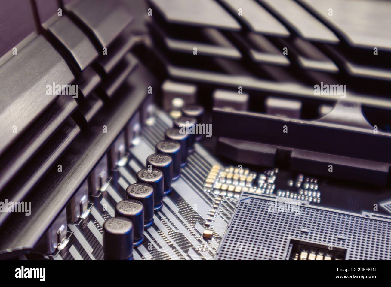 Powerful PC with AM4 CPU Socket on motherboard. Computer hardware chipset components close-up in blue light. Tech industry electronics background Stock Photo