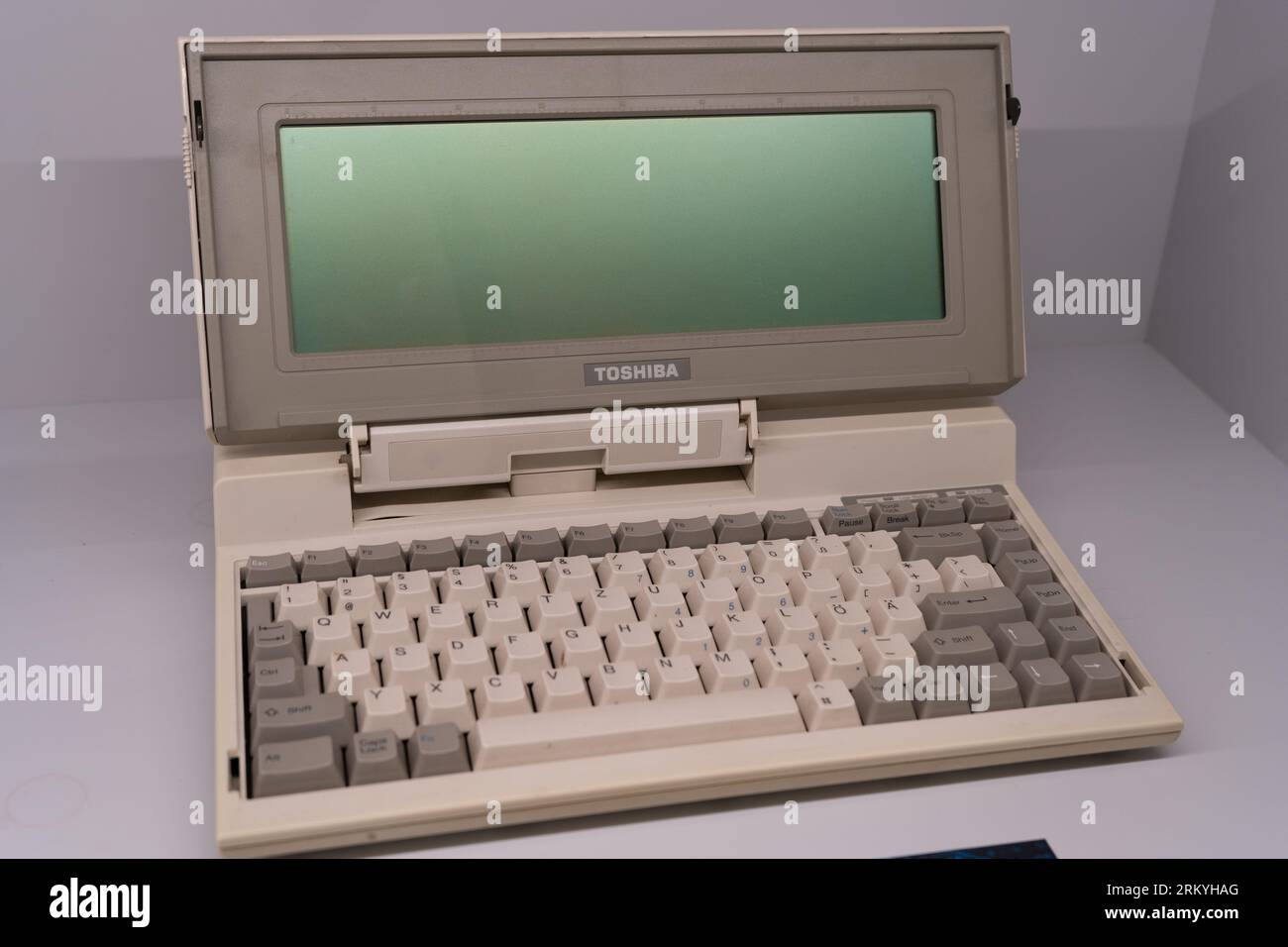 Old Toshiba laptop. Retro model. First personal computer. Small portable. Poland, Warsaw - July 27, 2023. Stock Photo