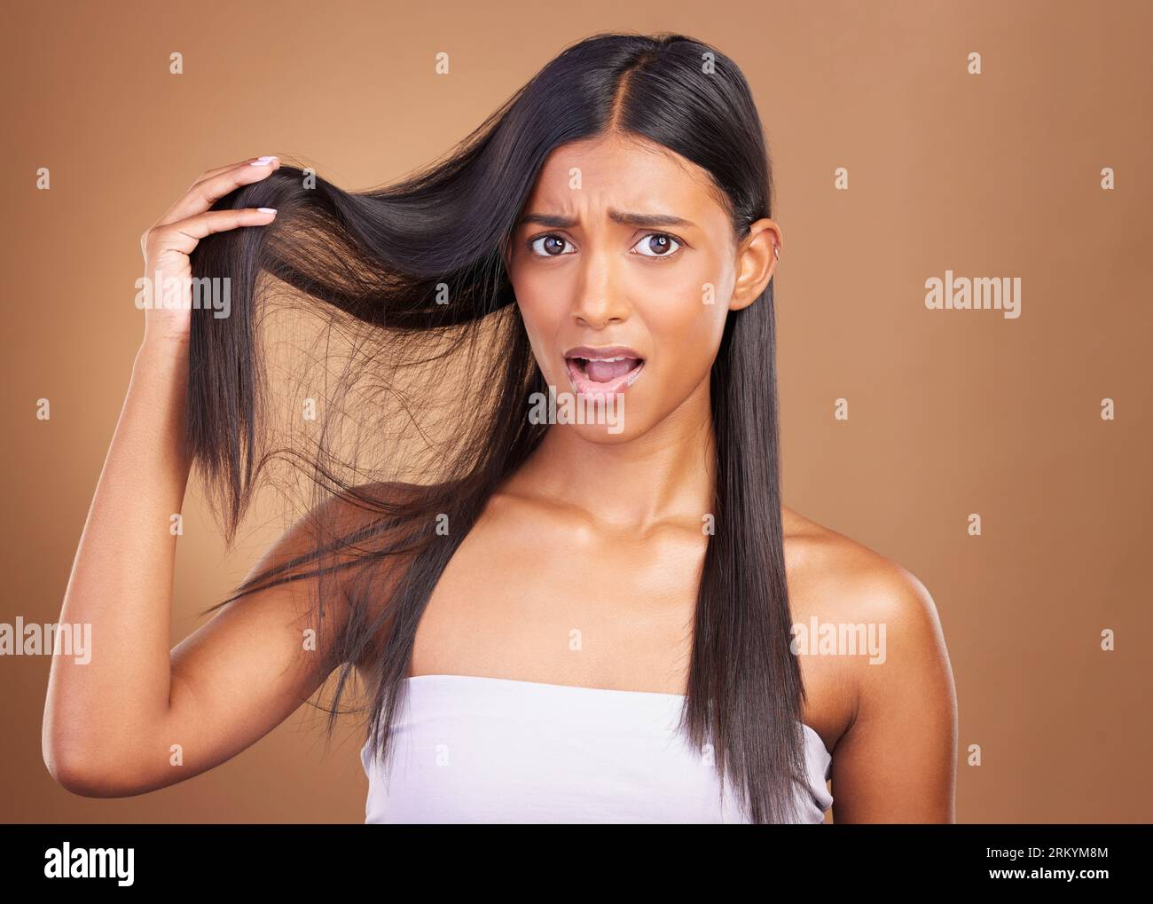 Beauty, crisis and portrait of woman with hair loss in studio worry, stress or anxiety for damage on brown background. Haircare, fail and lady model Stock Photo