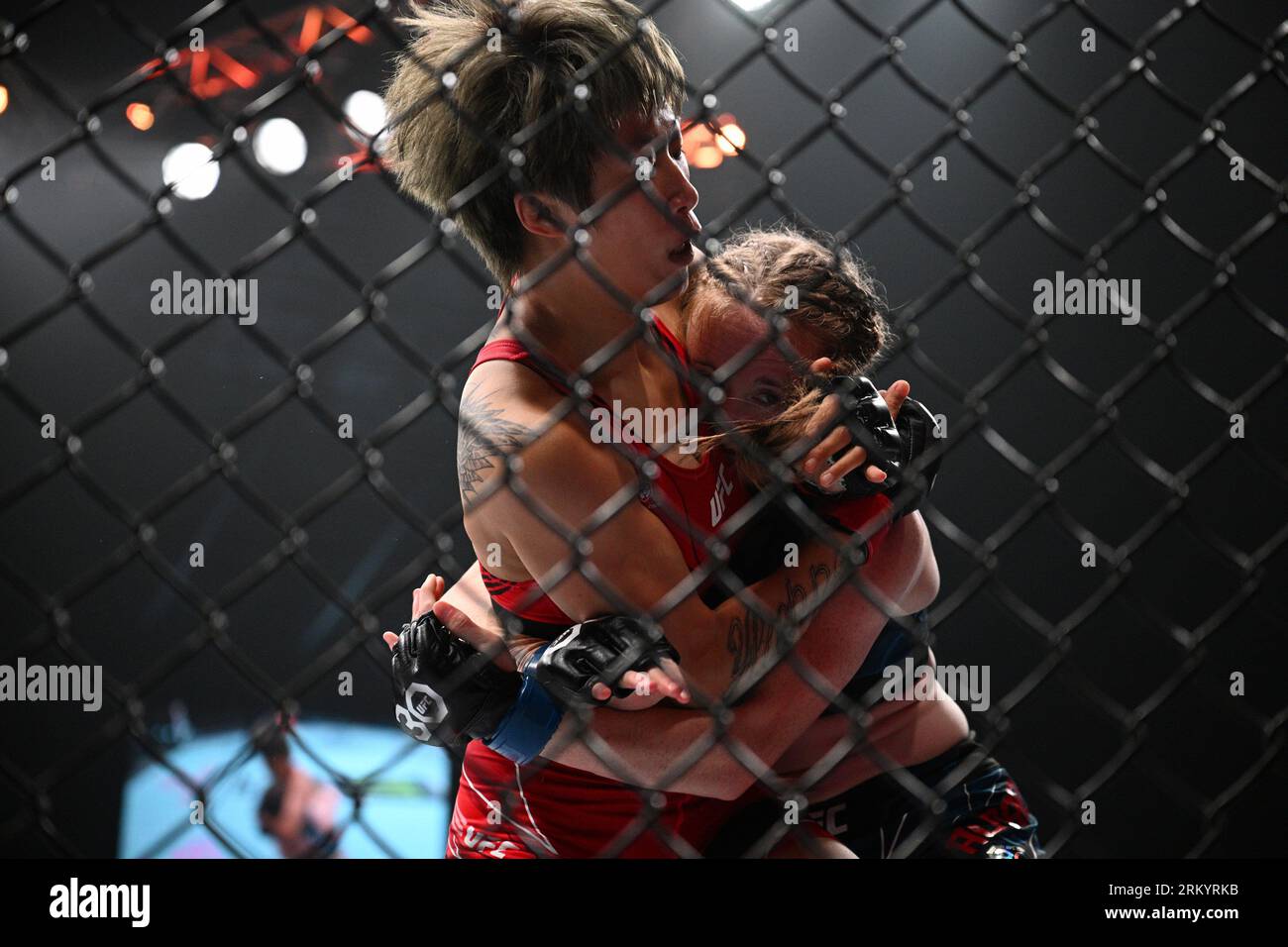 Singapore. 26th Aug, 2023. Liang Na (L) of China fights against JJ Aldrich of the United States during the women's flyweight bout of the UFC Fight Night held at Singapore Indoor Stadium in Singapore on Aug. 26, 2023. Credit: Then Chih Wey/Xinhua/Alamy Live News Stock Photo