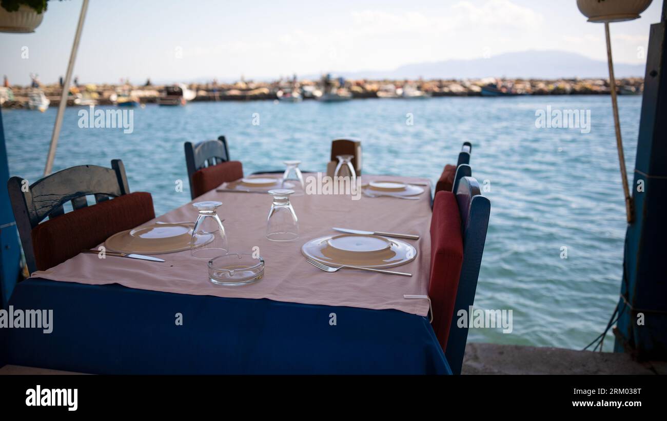 empty dining table by the sea. blue seaside restaurant Stock Photo