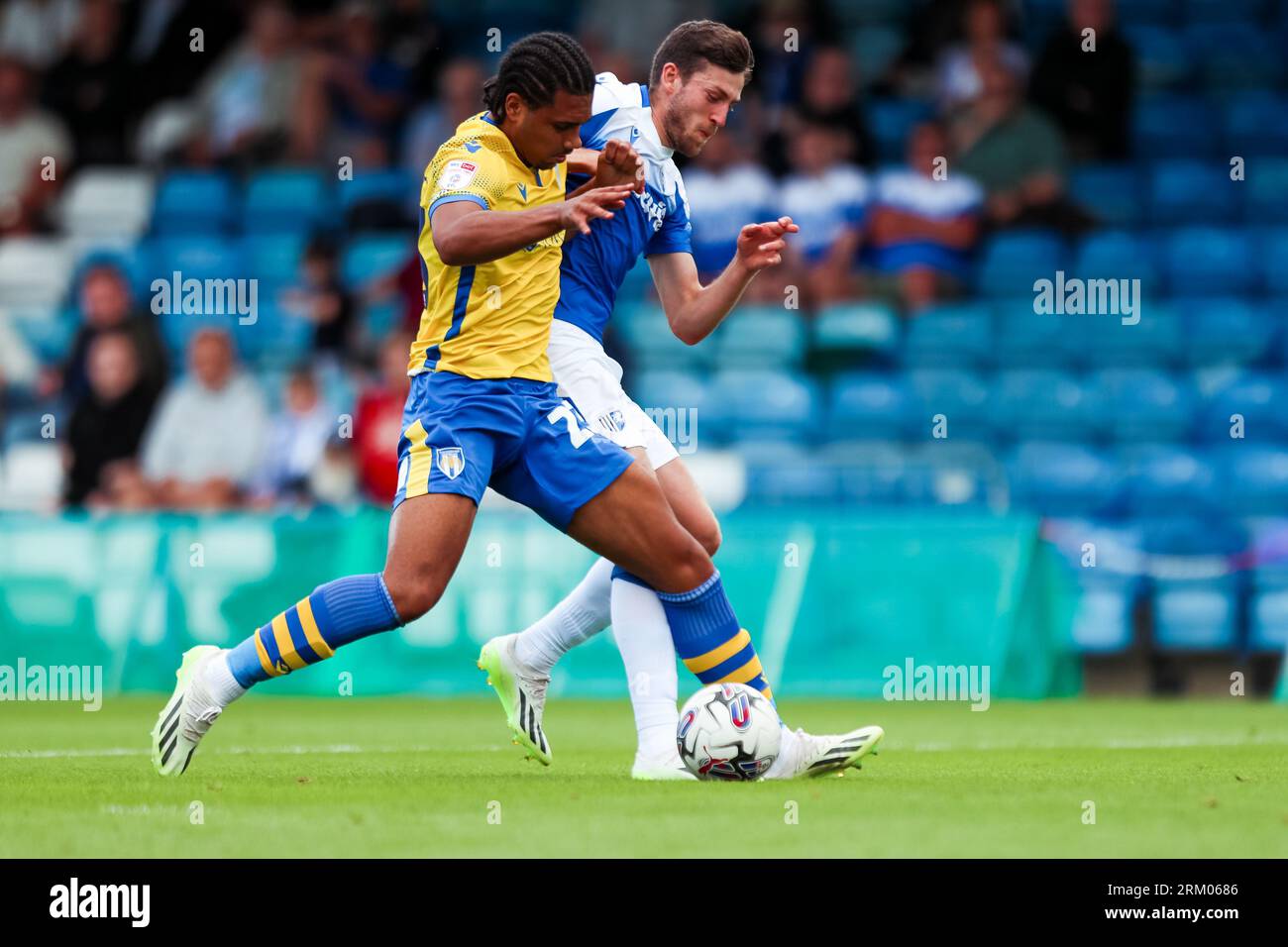 Gillingham's Ashley Nadesan and Colchester United's Nico Lawrence battle for the ball during the Sky Bet League Two match at Priestfield Stadium, Gillingham. Picture date: Saturday August 26, 2023. Stock Photo