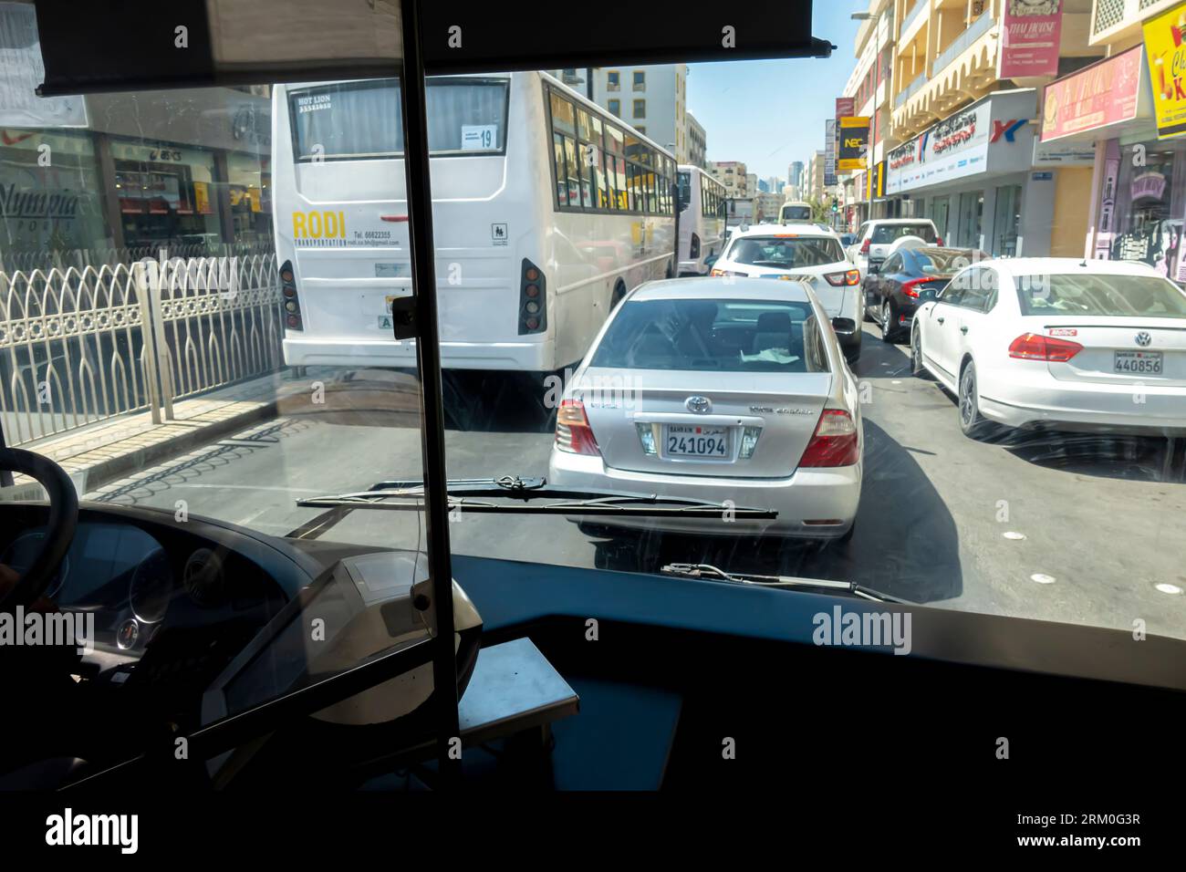 Day traffic in Manama Bahrain through the bus window Stock Photo