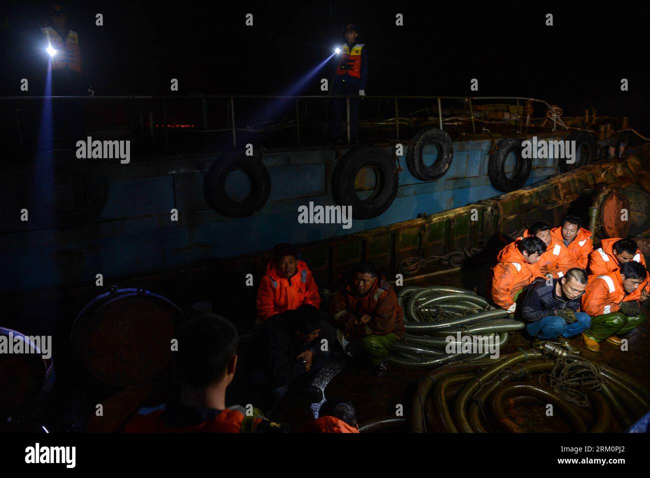 Bildnummer: 59463486  Datum: 29.03.2013  Copyright: imago/Xinhua Photo taken on March 29, 2013 shows police watching over smugglers on a boat offshore east China s Zhejiang Province. A gangs smuggling case involving 15,000 tons of refined oil worthy over 100 million Yuan (approximately 15.9 million U.S. dollars) was seized here on Sunday, as announced by Hangzhou customs on March 31, it is the biggest ever gangs smuggling case offshore Zhejiang province. (Xinhua/Xu Yu) (cxy) CHINA-ZHEJIANG-GANGS SMUGGLING CASE (CN) PUBLICATIONxNOTxINxCHN Gesellschaft Wirtschaft Kriminalität Öl Ölschmuggel Schm Stock Photo