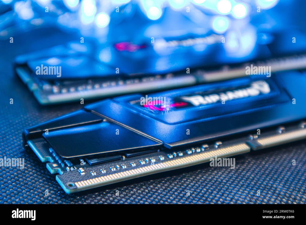 Kyiv, Ukraine - January 05, 2022: G.Skill Ripjaws V series memory module DDR4 DRAM with electrical contacts in blue light. Computer RAM chipset close- Stock Photo