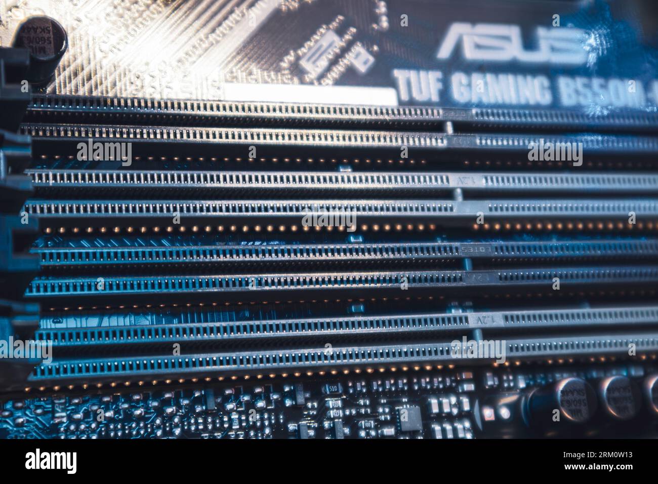 Kyiv, Ukraine - January 05, 2022: Asus Tuf Gaming motherboard, DDR RAM memory slots sockets close-up, desktop PC. Computer hardware chipset components Stock Photo