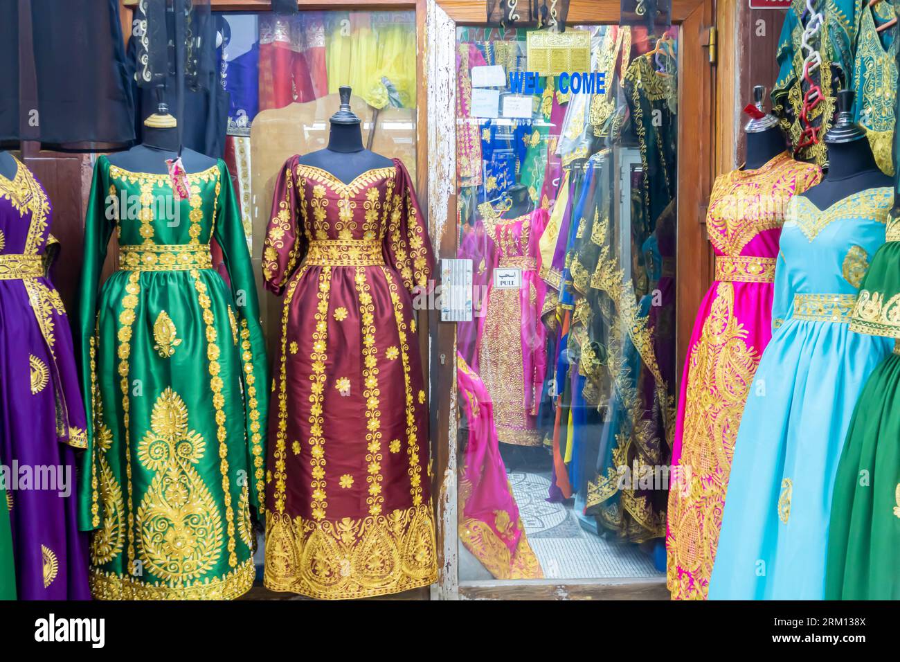 Colorful women's clothing sold in Manama Bahrain. Women's dresses on display in the store in Manama Bahrain Stock Photo