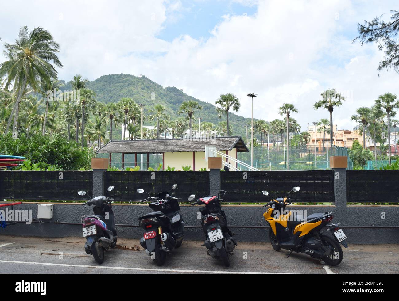 Phuket beach hotel with parked motorbikes. Stock Photo