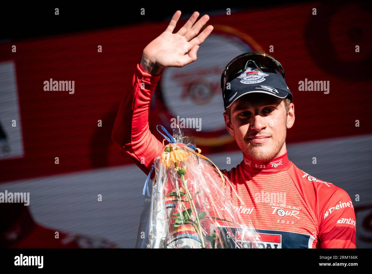 Essen, Germany. 26th Aug, 2023. Cycling: Tour of Germany, Arnsberg - Essen (174.00 km), stage 3. Ilan van Wilder from Belgium on the podium with the red jersey. Credit: Fabian Strauch/dpa/Alamy Live News Stock Photo