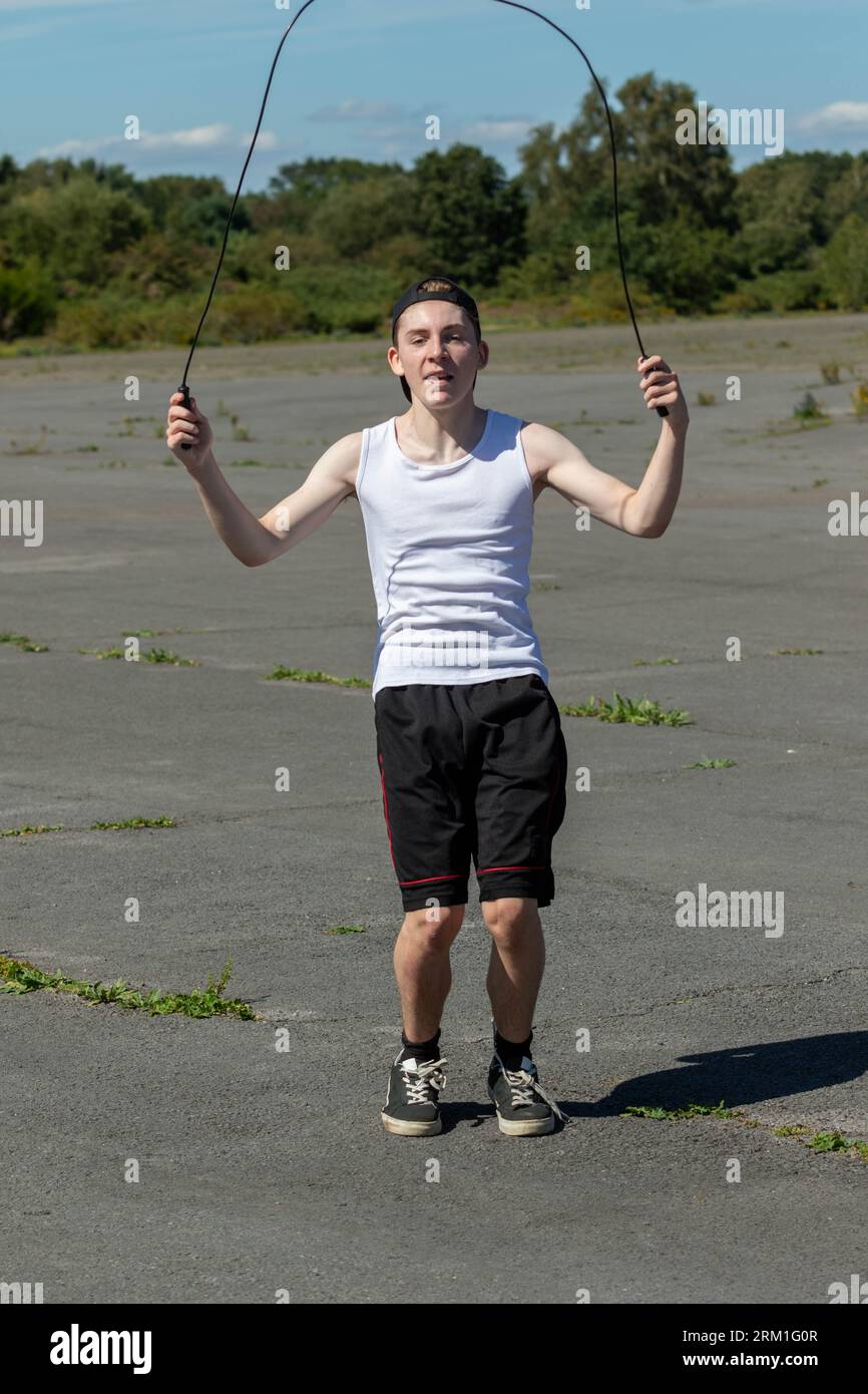 https://c8.alamy.com/comp/2RM1G0R/fit-and-sporty-teenage-boy-skipping-with-a-skipping-rope-on-a-warm-summers-afternoon-2RM1G0R.jpg