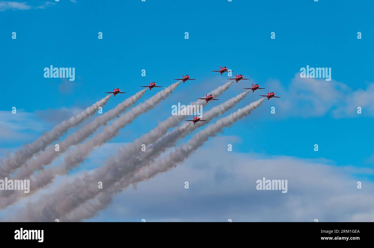 Red Arrows RAF Royal Air Force Aerobatics Display Team aeroplanes flying overhead in formation, UK Stock Photo