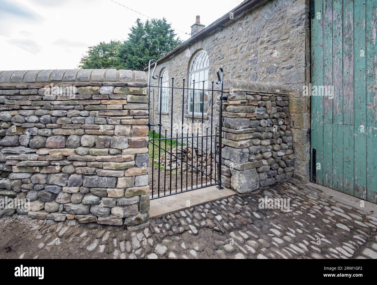 New wall and gate built  to high standard,located at the former old school building ,perhaps now used as a garagge, in Long Preston North Yorkshire Stock Photo