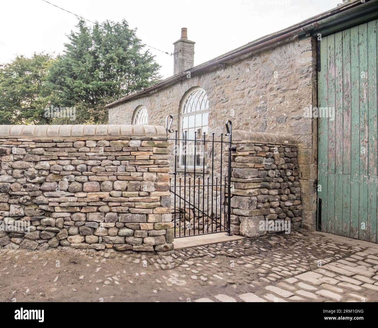 New wall and gate built  to high standard,located at the former old school building ,perhaps now used as a garagge, in Long Preston North Yorkshire Stock Photo