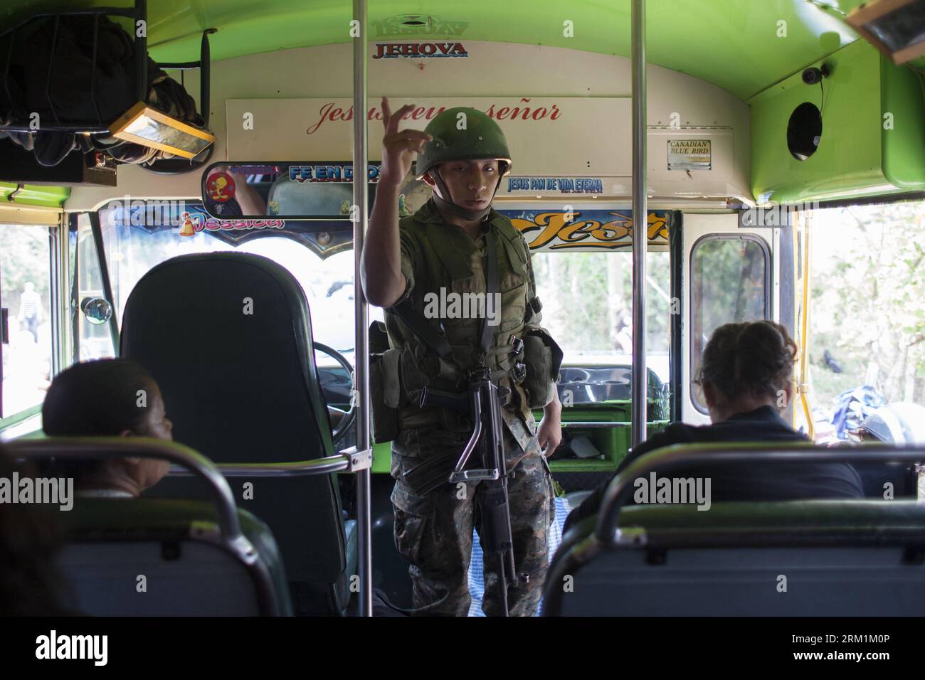 Bildnummer: 59597626  Datum: 03.05.2013  Copyright: imago/Xinhua (130503) -- MATAQUESCUINTLA, May 3, 2013 (Xinhua) -- A member of Guatemalan Army inspects a bus in Mataquescuintla, township of the department of Jalapa, Guatemala, on May 2, 2013. The government of Guatemalan President OttoPerezMolina decreed a state of emergency in four townships Thursday roiled by protests against a mining company, which resulted in two deaths. (Xinhua/Luis Echeverria) (fnc) (sp) (syq) GUATEMALA-MATAQUESCUINTLA-SECURITY-VIOLENCE PUBLICATIONxNOTxINxCHN xcb x2x 2013 quer premiumd o0 Gesellschaft Militär Soldat Stock Photo