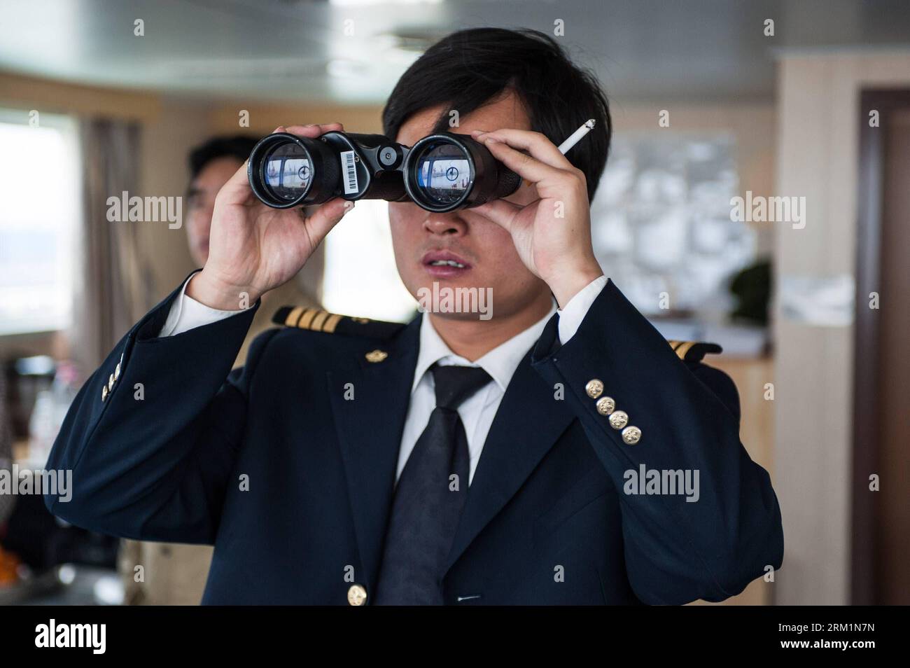 Bildnummer: 59604368  Datum: 24.04.2013  Copyright: imago/Xinhua NANJING, - Zhu Hui checks sailing conditions using telescope aboard the Maple Star on the Yangtze River in east China s Jiangsu Province, April 24, 2013. Wang Lianmiao and Zhu Hui arrived at the port of Jingjiang on the morning of April 24, 2013. Both men are inland waterway pilots from the Yangtze River Pilot Centre. Awaiting them was the Maple Star, a 180-meter-long Marshall Islands-flagged cargo ship with a gross register tonnage of over 23,000. Under their pilotage, the Maple Star was to veer 180 degrees and head downstream t Stock Photo