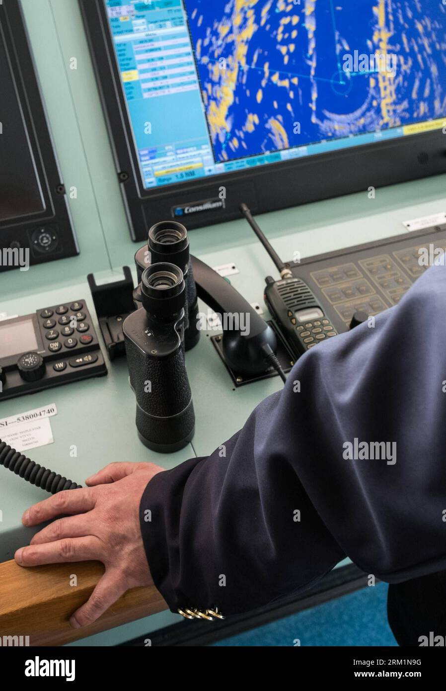 Bildnummer: 59604369  Datum: 24.04.2013  Copyright: imago/Xinhua NANJING, - Wang Lianmiao monitors a radar screen aboard the Maple Star on the Yangtze River in east China s Jiangsu Province, April 24, 2013. Wang Lianmiao and Zhu Hui arrived at the port of Jingjiang on the morning of April 24, 2013. Both men are inland waterway pilots from the Yangtze River Pilot Centre. Awaiting them was the Maple Star, a 180-meter-long Marshall Islands-flagged cargo ship with a gross register tonnage of over 23,000. Under their pilotage, the Maple Star was to veer 180 degrees and head downstream to the port o Stock Photo