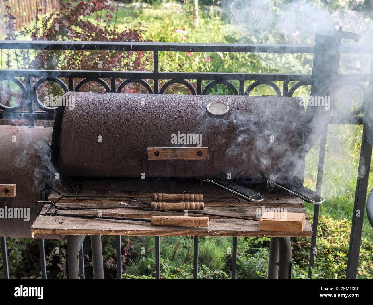 Two whole trout fish being grilled on barbecue Stock Photo
