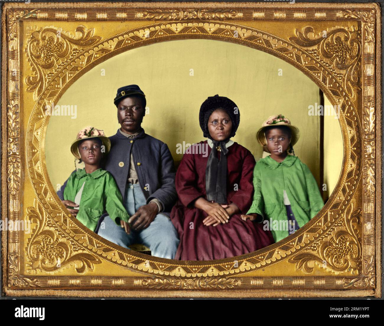 Sgt. Samuel Smith, African American soldier of the 119th USCT, in Union uniform with his wife Mollie, and his daughters Mary and Maggie. Between 1863 Stock Photo
