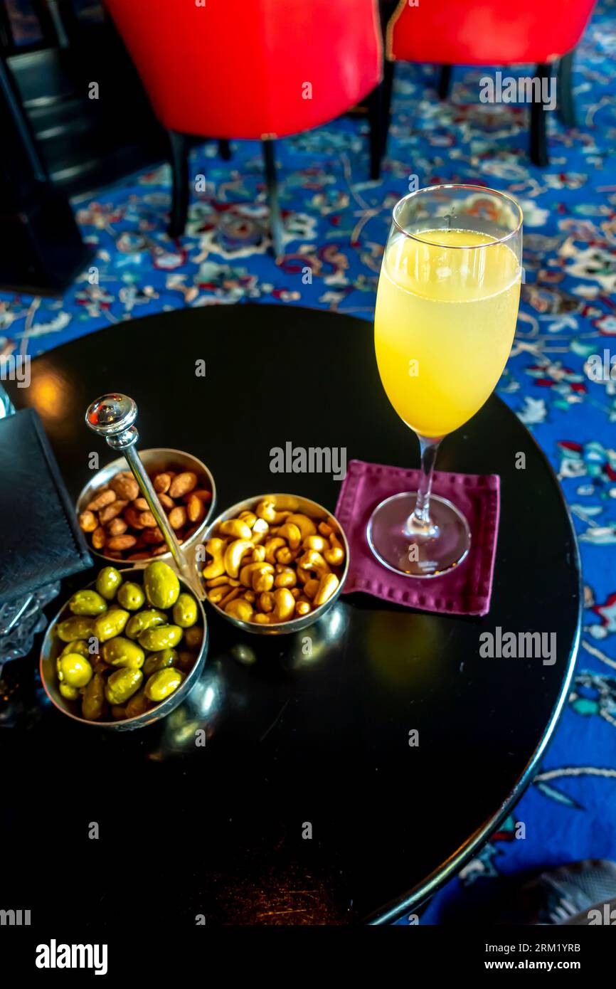 A glass of Bellini cocktail served Burlington Club bar interior, Al Seef District, Manama, Bahrain Stock Photo