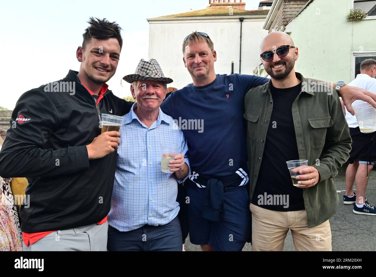 Dartmouth, UK. 26th Aug, 2023. 26th/August/2023. A group of locals seen enjoying themselves at the Bank holiday weekend, at The Port of Datmouth Royal Regatta. Picture Credit: Robert Timoney/Alamy Live News Stock Photo