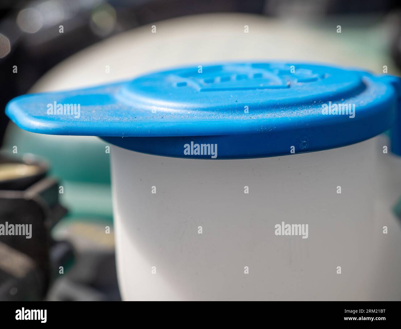 Reservoir of the windshield washer system of the car. Closeup of a