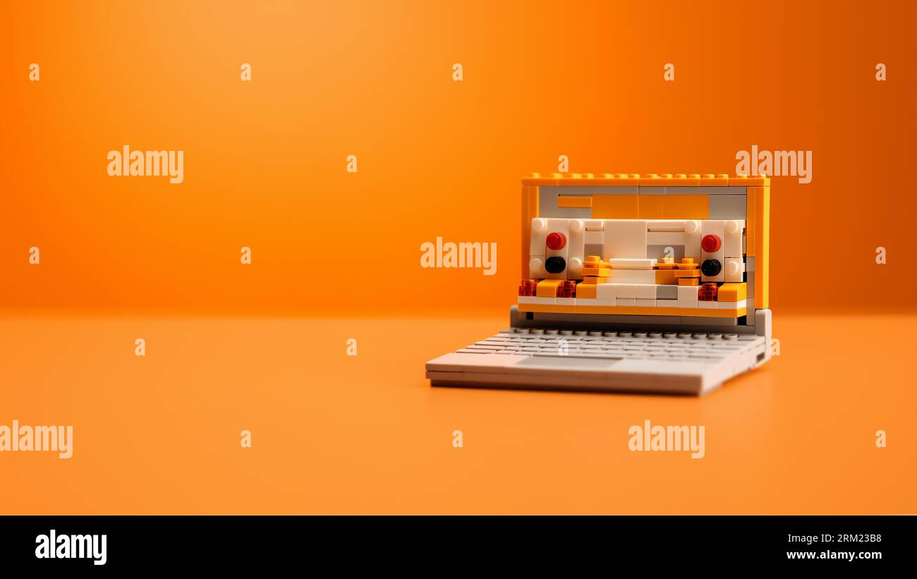 3D Laptop made of plastic block toys with orange color Stock Photo