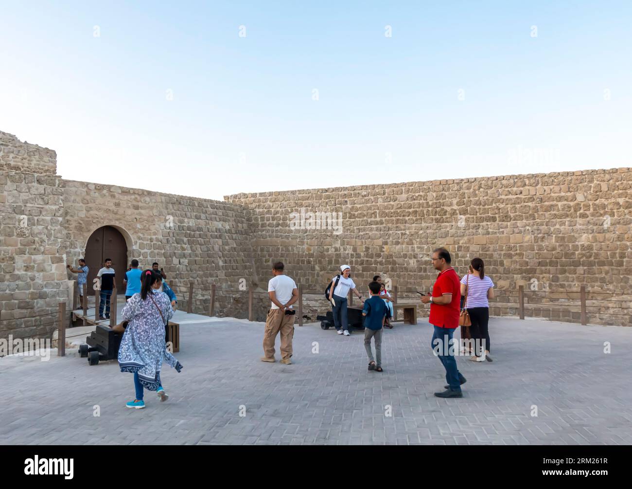 Tourists at Qal'at al-Bahrain - Bahrain Fort, Fortress in Al Qala, Bahrain Stock Photo