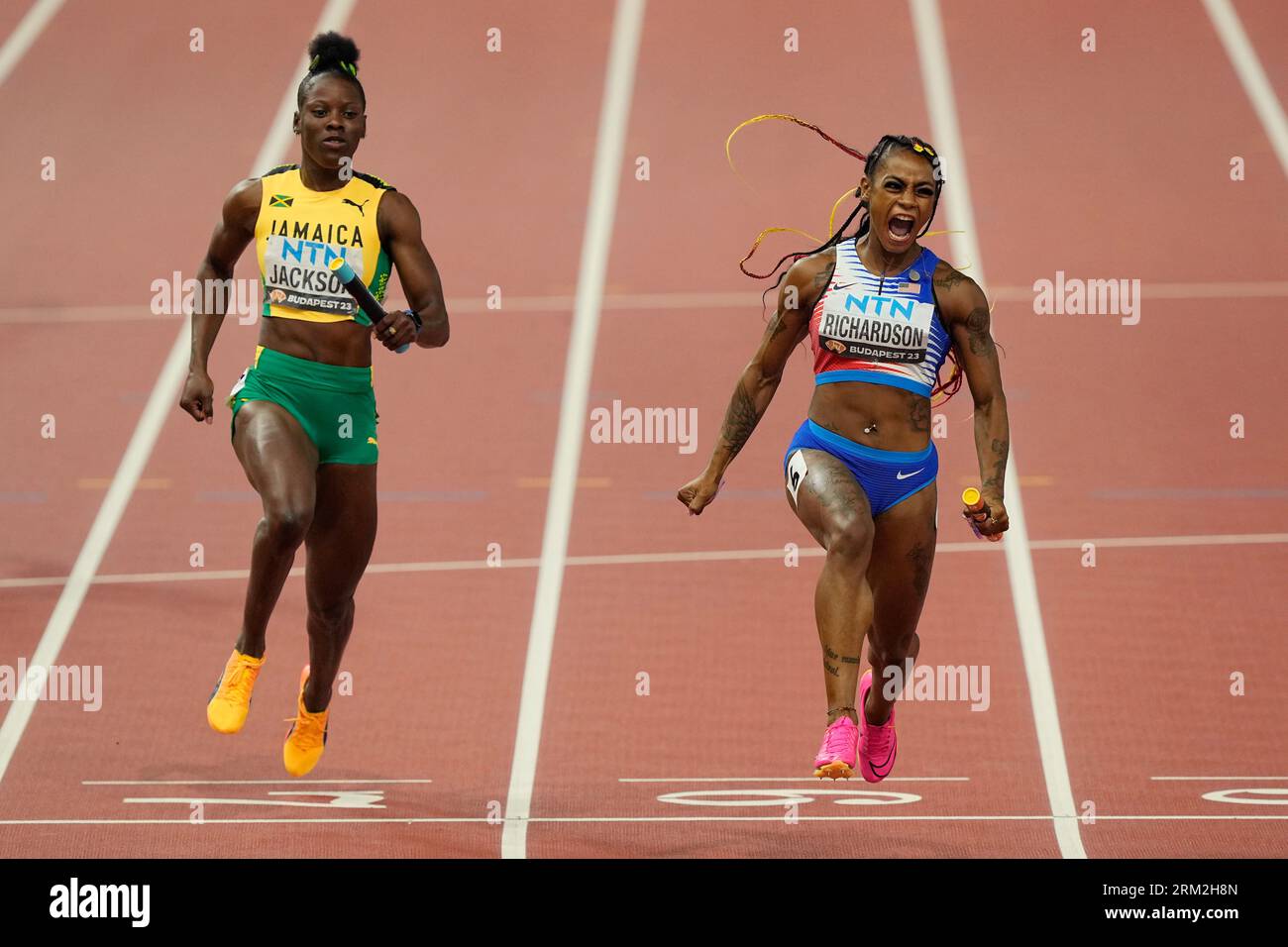 Sha'Carri Richardson, of the United States celebrates anchoring her