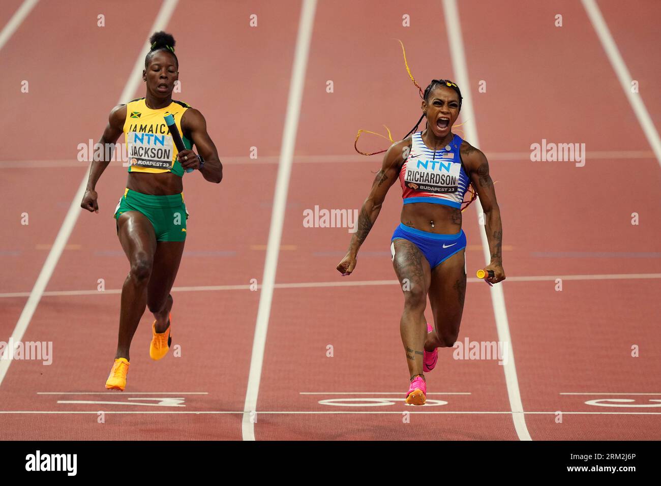 Sha'Carri Richardson, of the United States celebrates anchoring her