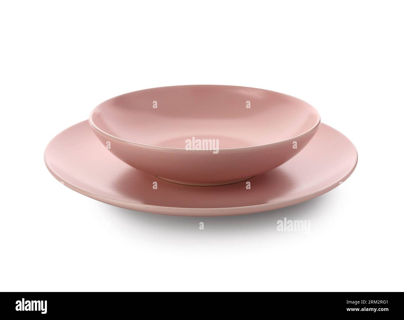 Pink ceramic plates on white background Stock Photo - Alamy