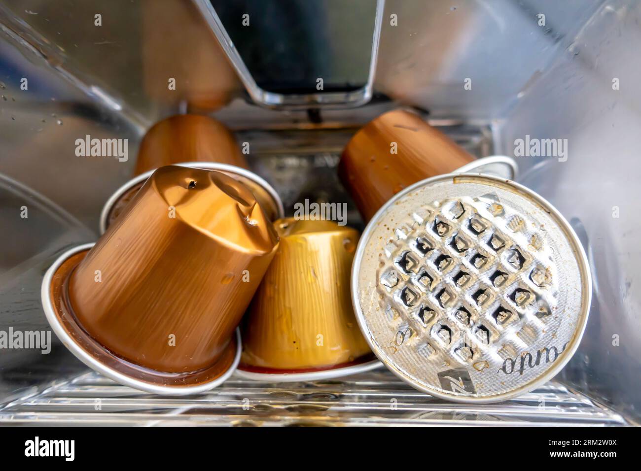 Used espresso coffee capsules. Nespresso coffee capsule discarded. Coffee pods in the machine used, Punctured nespresso capsules, Pierced coffee pods Stock Photo