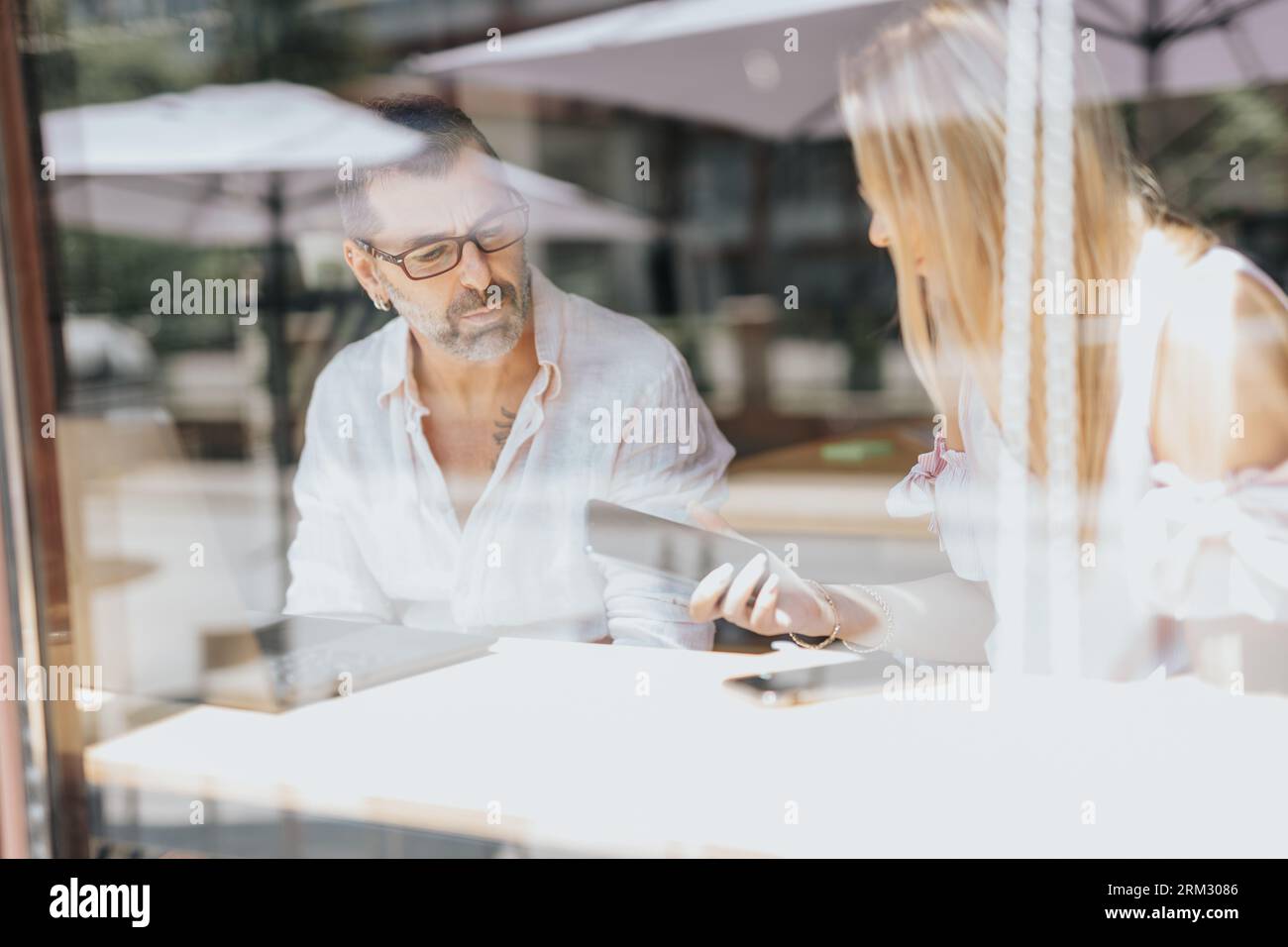 Businesspeople discussing innovative ideas, analyzing statistics, and problem-solving in a multicultural office setting. Stock Photo